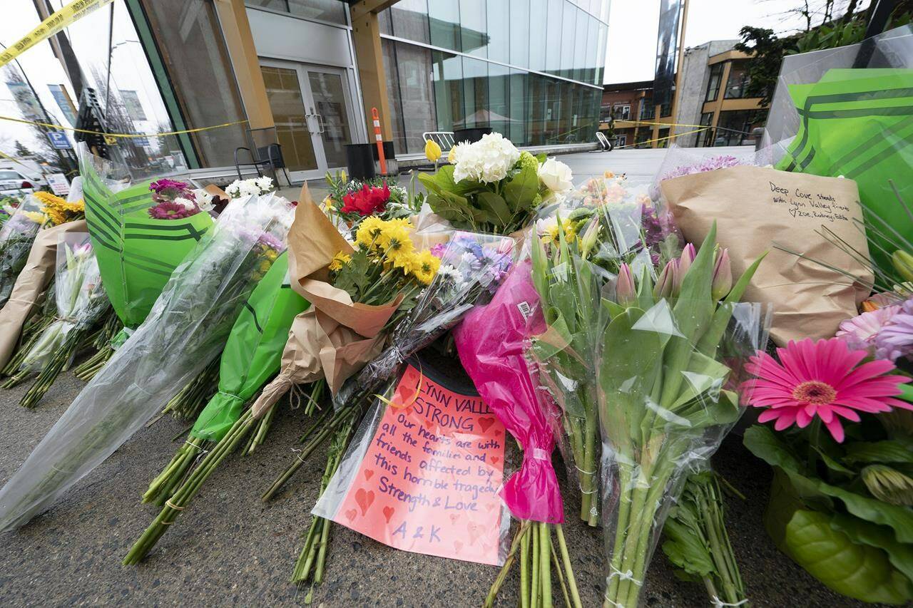 Flowers and notes are seen at a makeshift memorial outside of the Lynn Valley Library in Lynn Valley in North Vancouver, B.C., Sunday, March 28, 2021. Victims of a stabbing spree two years ago in North Vancouver told the court their lives were shattered by Yannick Bandaogo’s fatal attack in and around a Lynn Valley library. THE CANADIAN PRESS/Jonathan Hayward
