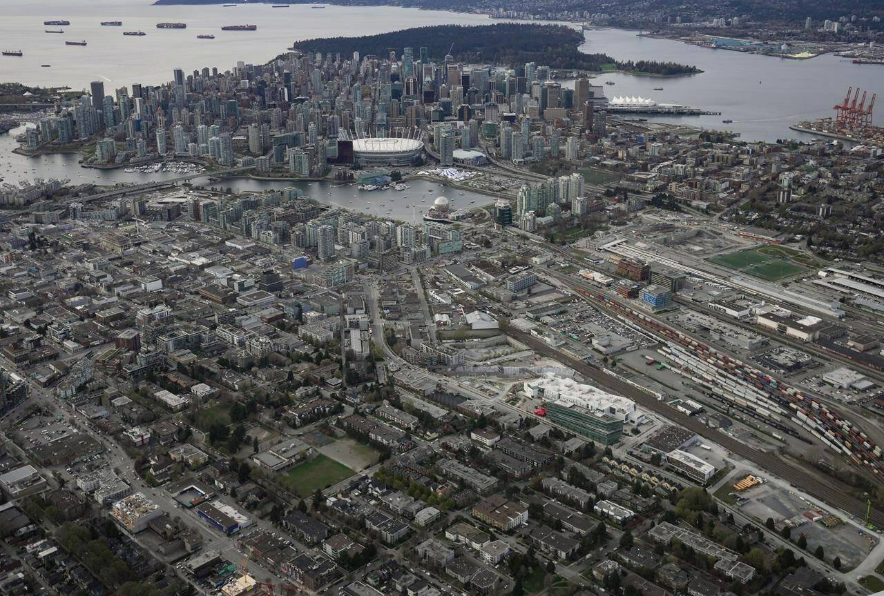 The downtown Vancouver skyline is seen in an aerial view from east Vancouver, on Saturday, April 9, 2022. Airbnb has won a court ruling that quashes an order from British Columbia’s privacy commissioner that would have identified hosts and their home addresses in Vancouver. THE CANADIAN PRESS/Darryl Dyck
