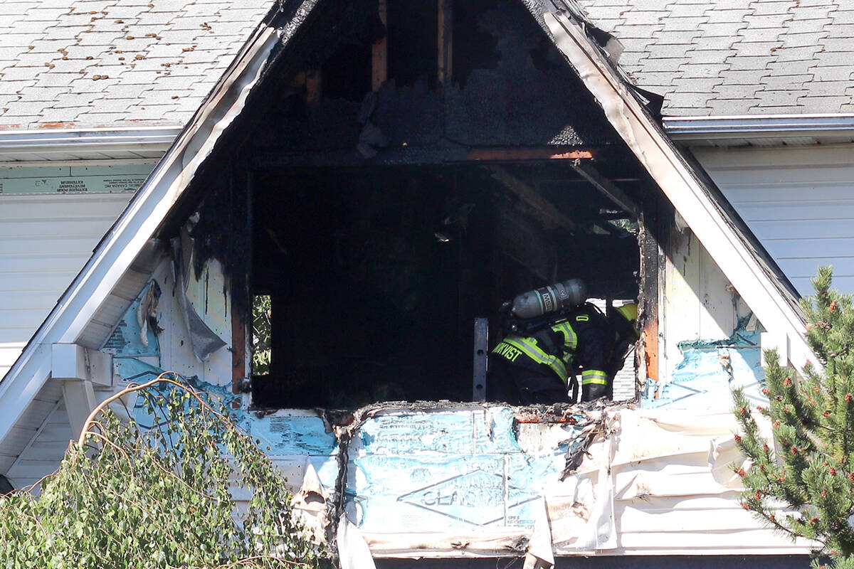 Firefighters put out a house fire at the corner of Wellesley Avenue and 106th Street on Sunday, July 9. (Greg Sakaki/News Bulletin)