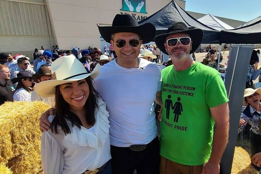 Federal Conservative Leader Pierre Poilievre and his wife, Anaida, pose for a photo with an unidentified man wearing a “straight pride” T-shirt during a Calgary Stampede event in Calgary, Alta., in a recent photo published to Twitter by user @BSpence1983. THE CANADIAN PRESS/HO-Twitter