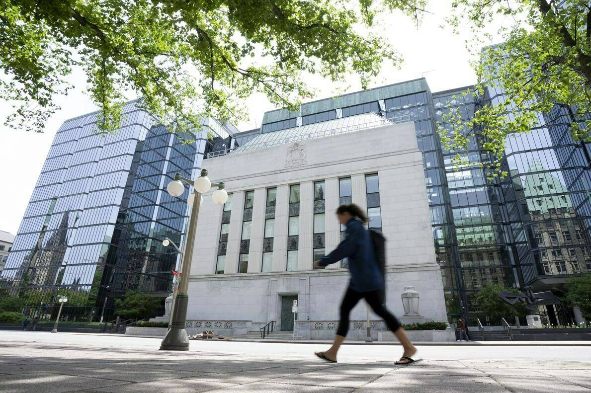 This week, the Bank of Canada hiked interest rates yet again, raising its key interest rate by a quarter of a percentage point to 5 per cent, and the prime rate to 7.2 per cent. A woman walks past the Bank of Canada headquarters in Ottawa, Wednesday, June 1, 2022. THE CANADIAN PRESS/Adrian Wyld