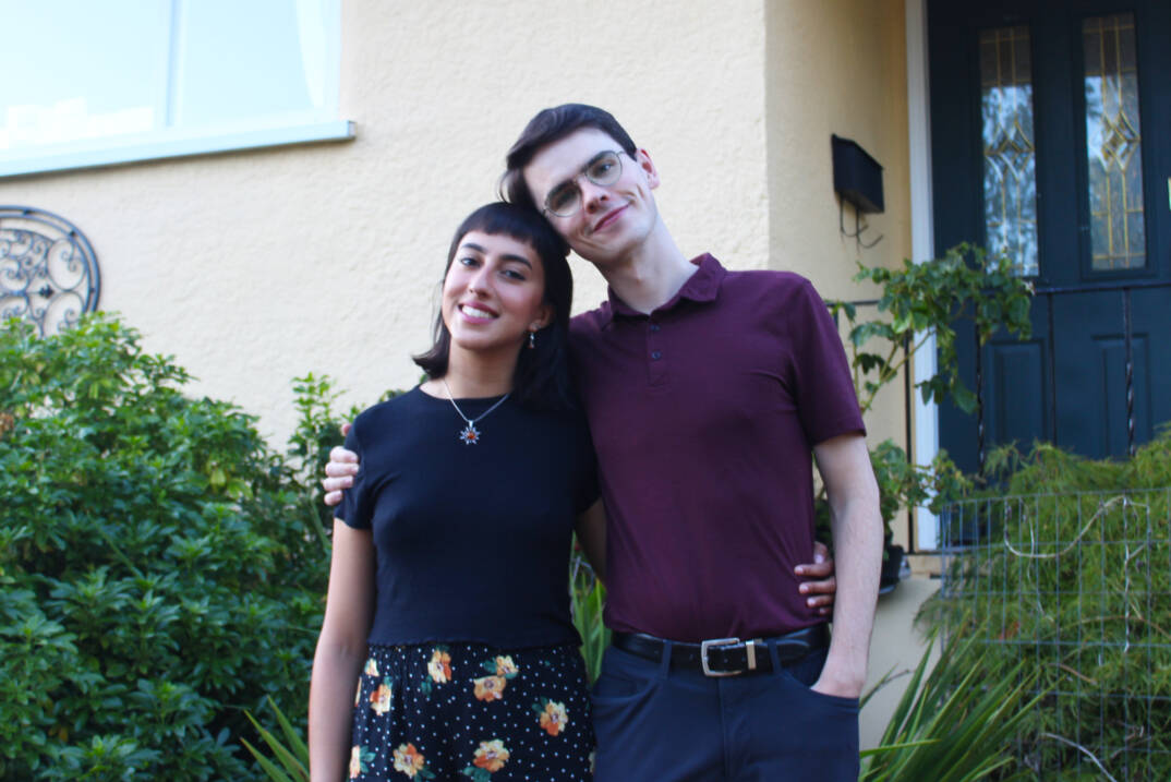 Tara Mathur and Jeremy Laceey standing in front of the yellow home Laceey currently lives at in Saanich. (Ella Matte/News Staff)