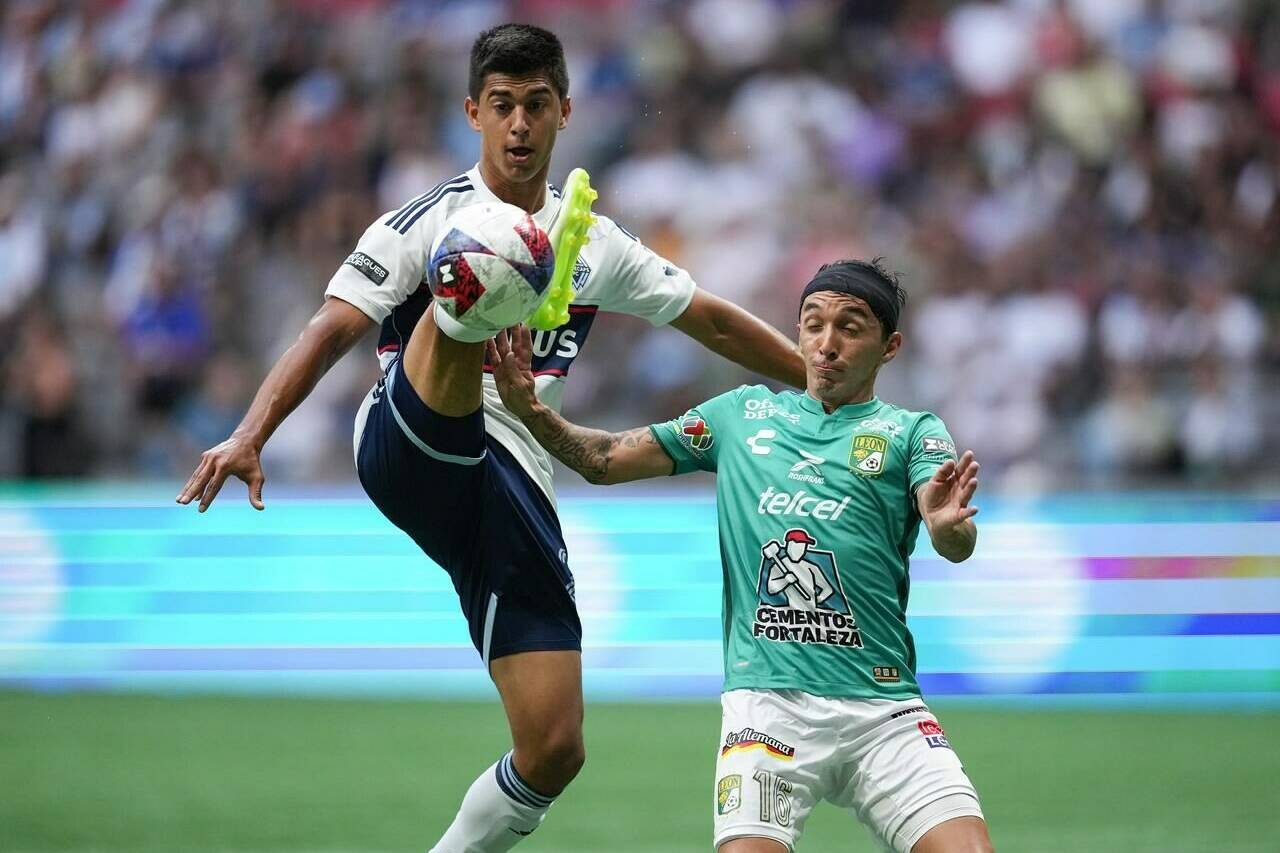 Vancouver Whitecaps’ Mathias Laborda, left, knocks down a pass intended for Club Leon’s Omar Fernandez with his foot during the first half of a Leagues Cup soccer match in Vancouver, on Friday, July 21, 2023. THE CANADIAN PRESS/Darryl Dyck
