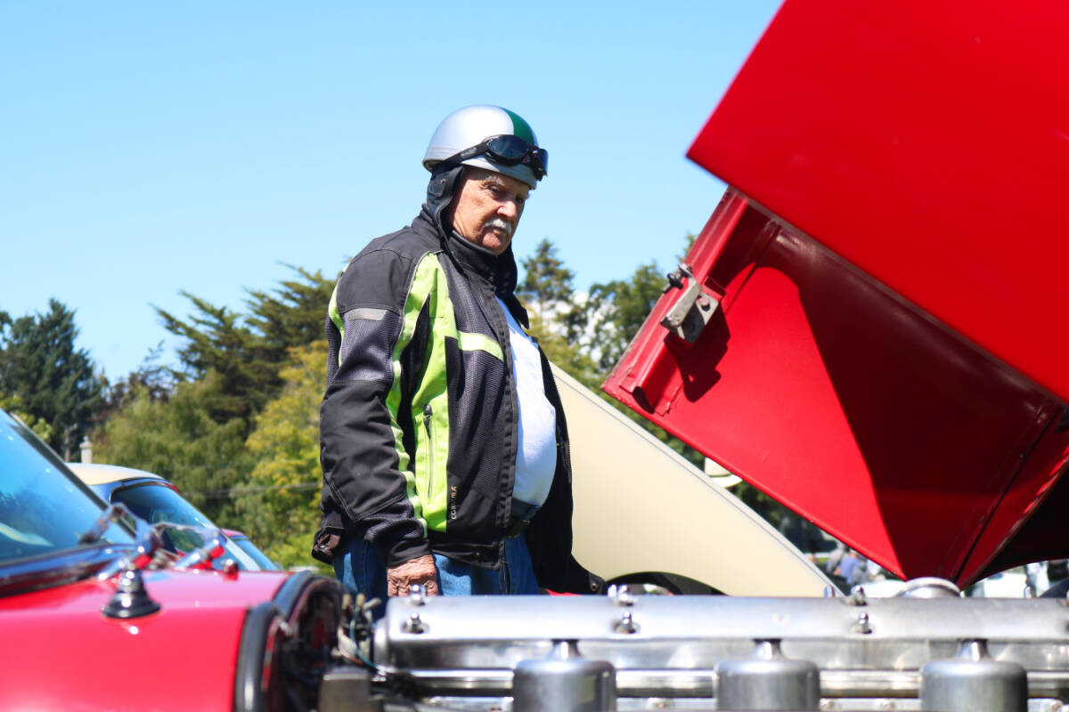 Bob Leach takes in some of the cars on display during the annual Jaguars on the Island event on Saturday (July 22) in Oak Bay. (Bailey Moreton/News Staff)