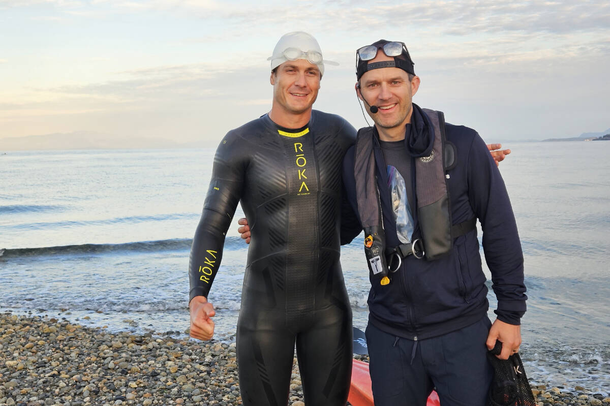 Scott Rees, a blind man, left prepares to depart for his successful swim across Georgia Strait on Sunday, July 22 to raise money for Canadian Guide Dogs for the Blind. (Photo submitted)