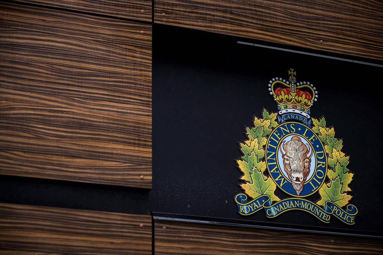 The RCMP logo is seen outside Royal Canadian Mounted Police “E” Division Headquarters, in Surrey, B.C., on April 13, 2018. A B.C. RCMP officer is keeping his job – but transferring – following five allegations of harrassment, which all took place at “E” Division. THE CANADIAN PRESS/Darryl Dyck