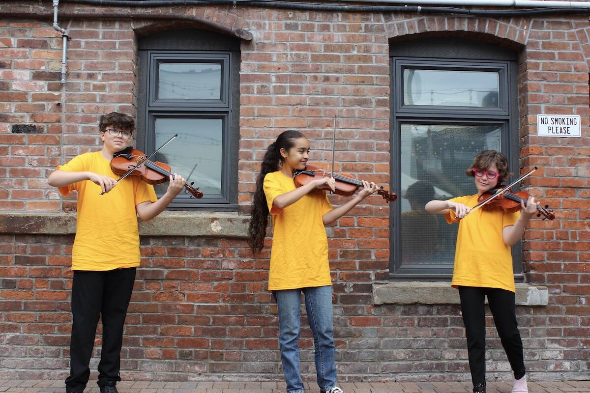 Sizzlers Fiddle Group members Toben Elder, Malak El Ouadghiri and Noa Paster bring their fiddle tunes to the streets of downtown Victoria several times per week. (Natasha Baldin/News Staff)