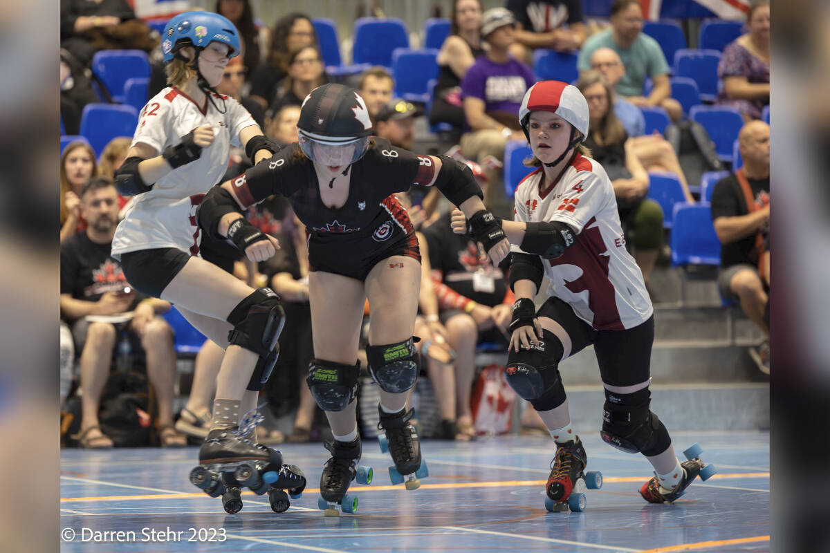 Naomi Morrell, aka Scream Soda, powers through the Denmark team at the Junior Roller Derby World Cup – held in Valence, France from July 28 to 30. (Courtesy of Darren Stehr/derbyphotos.ca)