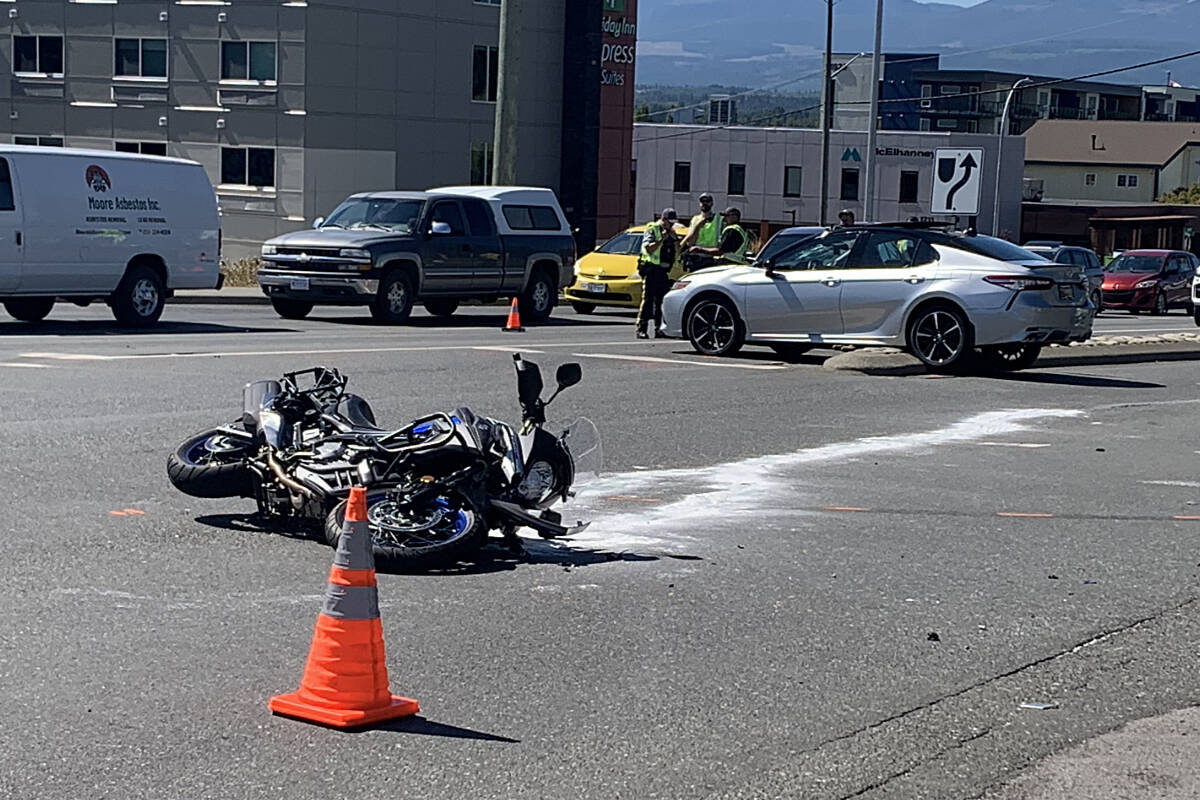 A motorcycle is seen keeled over after a crash late this morning (Aug 3) in Courtenay. The motorcyclist was hospitalized with serious injuries. (Terry Farrell/Comox Valley Record)