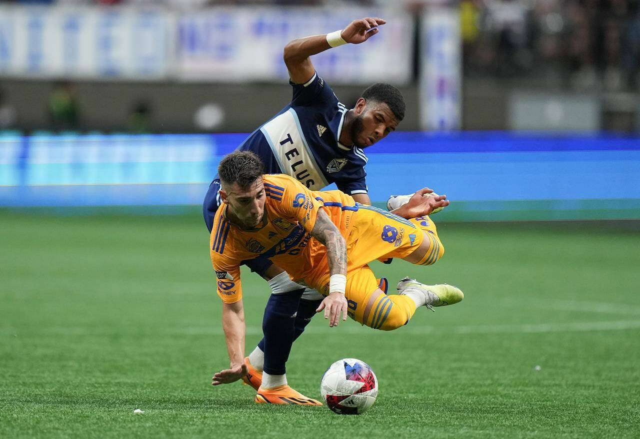 Tigres’ Fernando Gorriaran, front, is upended by Vancouver Whitecaps’ Pedro Vite as they vie for the ball during the first half of a Leagues Cup soccer match in Vancouver, on Friday, August 4, 2023. THE CANADIAN PRESS/Darryl Dyck