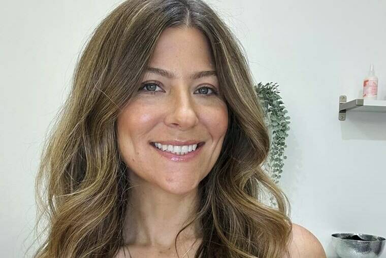 This image provided by Andrea Pezzillo shows Pezzillo, a hair stylist and men’s groomer, on Aug. 1, 2023, in Los Angeles. She is among hundreds of ancillary workers in the entertainment industry impacted by the Hollywood strikes. (Andrea Pezzillo via AP).