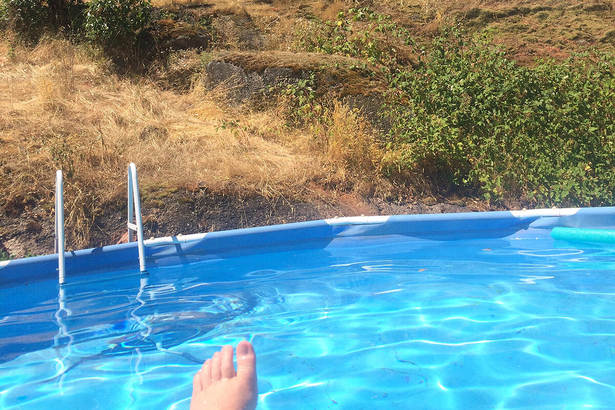 Floating in the pool and listening to music go hand in hand (or foot). (Philip Wolf photo)