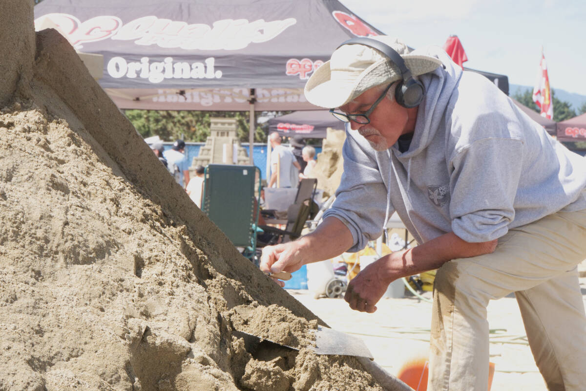 Ted Siebert works on his sculpture during the Quality Foods Sand Sculpting Competition on July 16 in Parksville. (Kevin Forsyth photo)