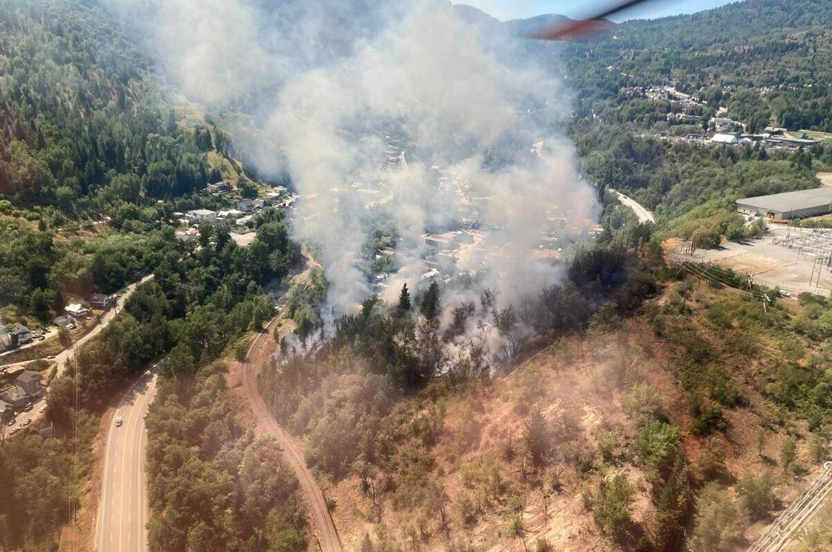 Crews worked quickly to douse flames that broke out Sunday on a hill just above Teck Resources’ Trail operations, potentially threatening the work site as well as some homes near the community of Warfield, B.C. Smoke from the fire is shown in this handout from BC Wildfire Service. THE CANADIAN PRESS/HO-BC Wildfire Service