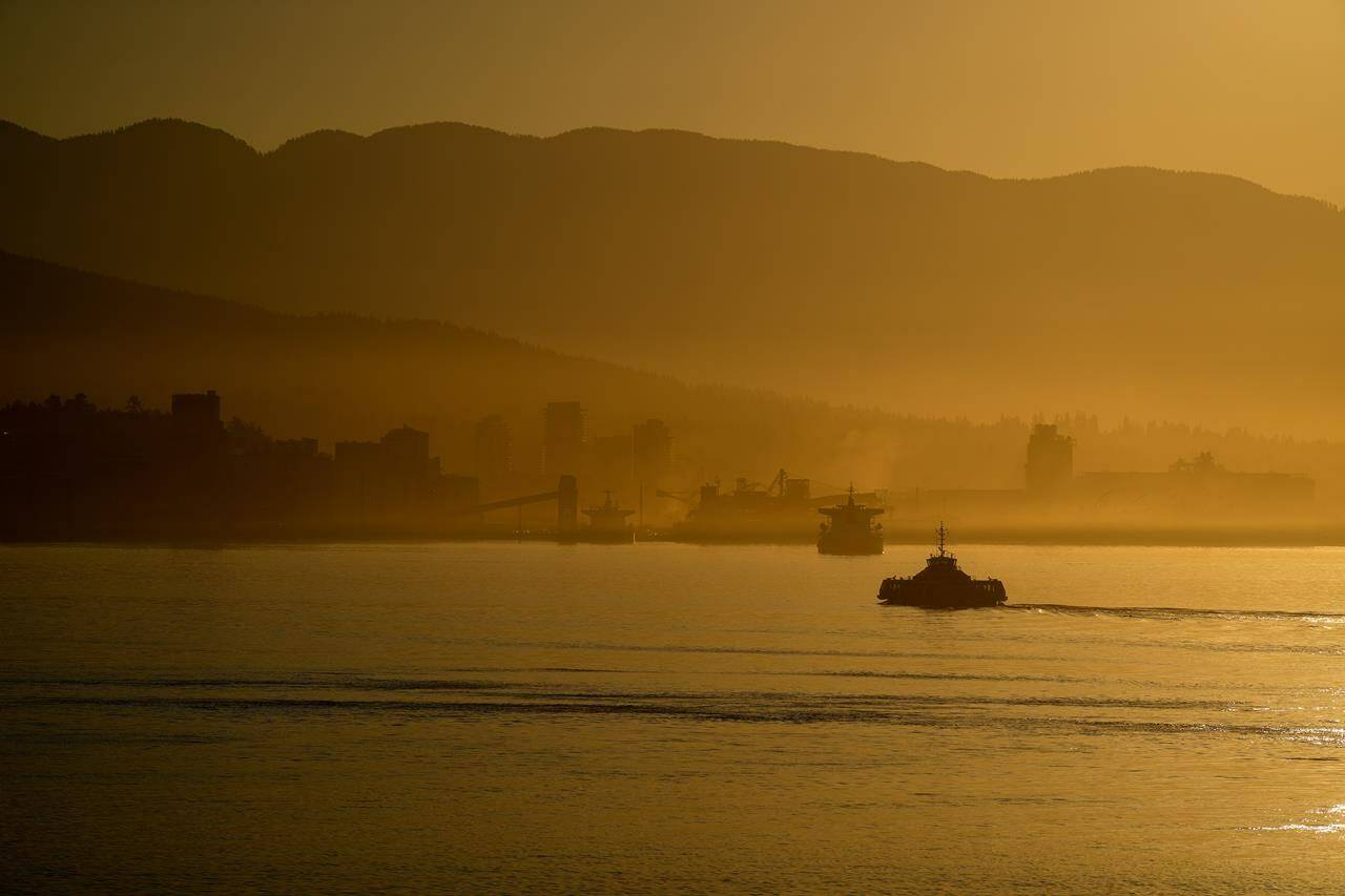 A marine layer hangs in the air as a SeaBus passenger ferry crosses Burrard Inlet, in Vancouver, on Monday, Aug. 14, 2023. As temperature records are shattered across southern British Columbia this week amid a scorching heat wave, the Wildlife Rescue Association of BC is sounding the alarm about the ongoing risks to animals. THE CANADIAN PRESS/Darryl Dyck