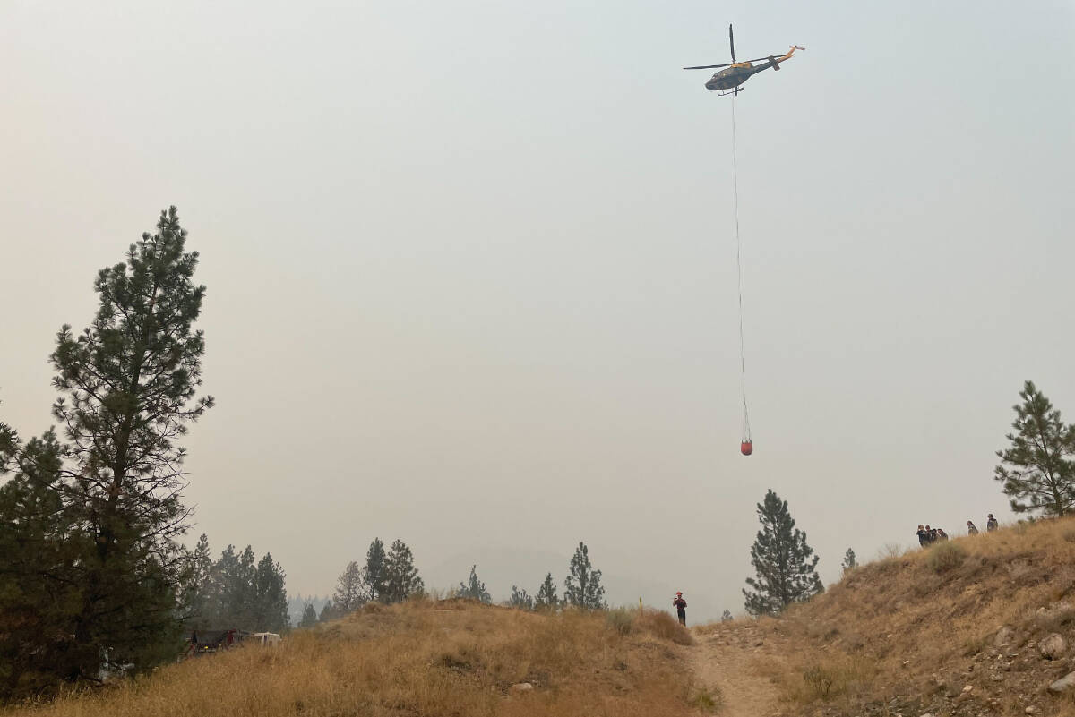Crews are responding a fast-moving grass fire on Saturday, Aug. 19, in West Bench. (Brennan Phillips/Western News)