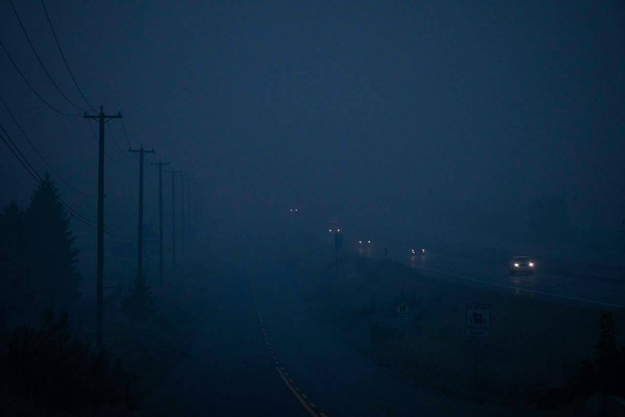 Thick smoke from wildfires burning in the area hangs in the air as motorists travel on the Trans-Canada Highway east of Kamloops, B.C., on Sunday, August 20, 2023. THE CANADIAN PRESS/Darryl Dyck