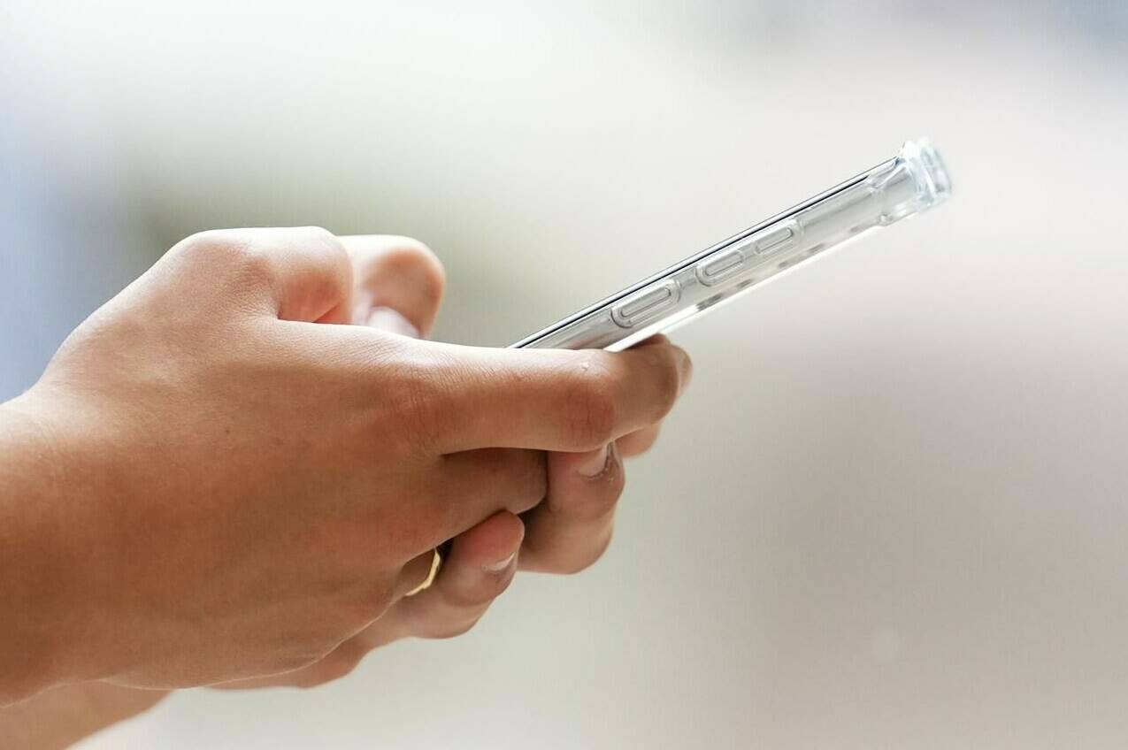 It’s the final bell for cellphones in Quebec classrooms as the province’s Education Department plans to ban their use in most teaching settings. A person uses a cellphone in Ottawa in this Monday, July 18, 2022 file photo. THE CANADIAN PRESS/Sean Kilpatrick