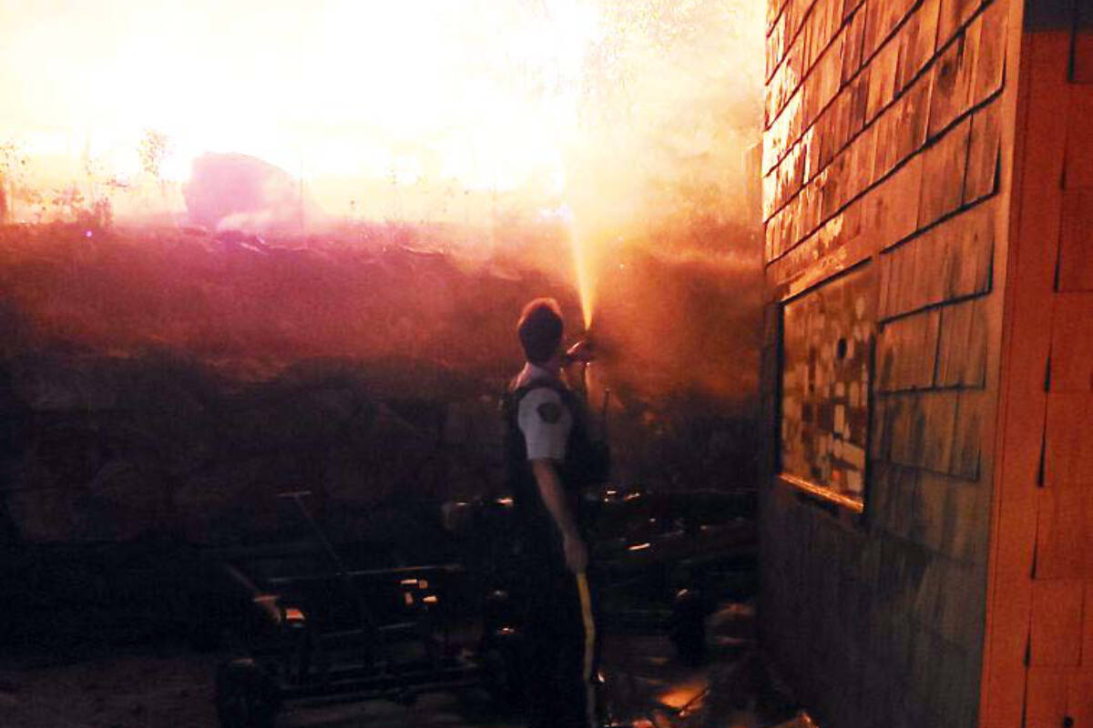 RCMP Cst. Borg captured fighting a spot fire on West Kelowna’s Parkinson Road. (Photo- Kelowna RCMP)