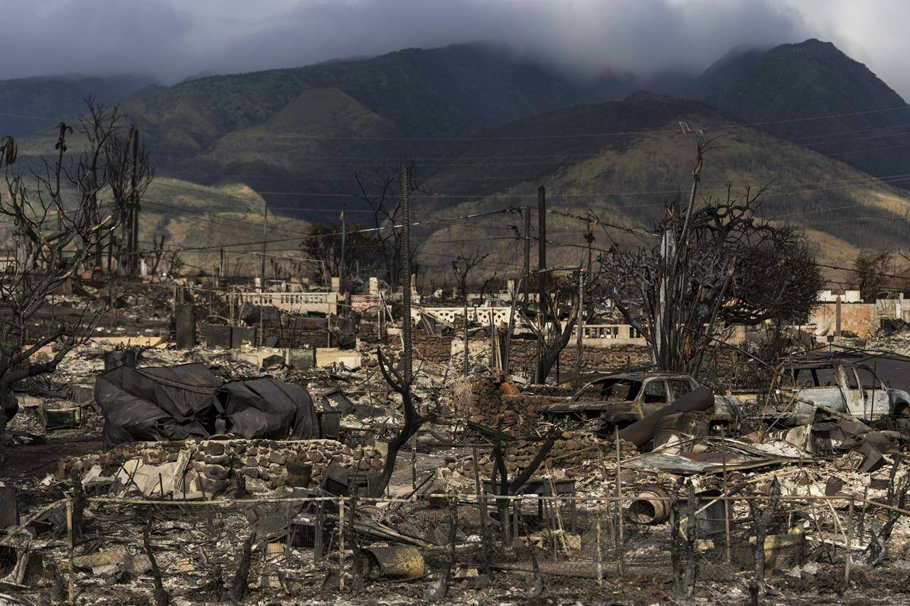 FILE - A general view shows the aftermath of a wildfire in Lahaina, Hawaii, Monday, Aug. 21, 2023. Hawaii’s electric utility acknowledged its power lines started a wildfire on Maui but faulted county firefighters for declaring the blaze contained and leaving the scene, only to have a second wildfire break out nearby and become the deadliest in the U.S. in more than a century. (AP Photo/Jae C. Hong, File)