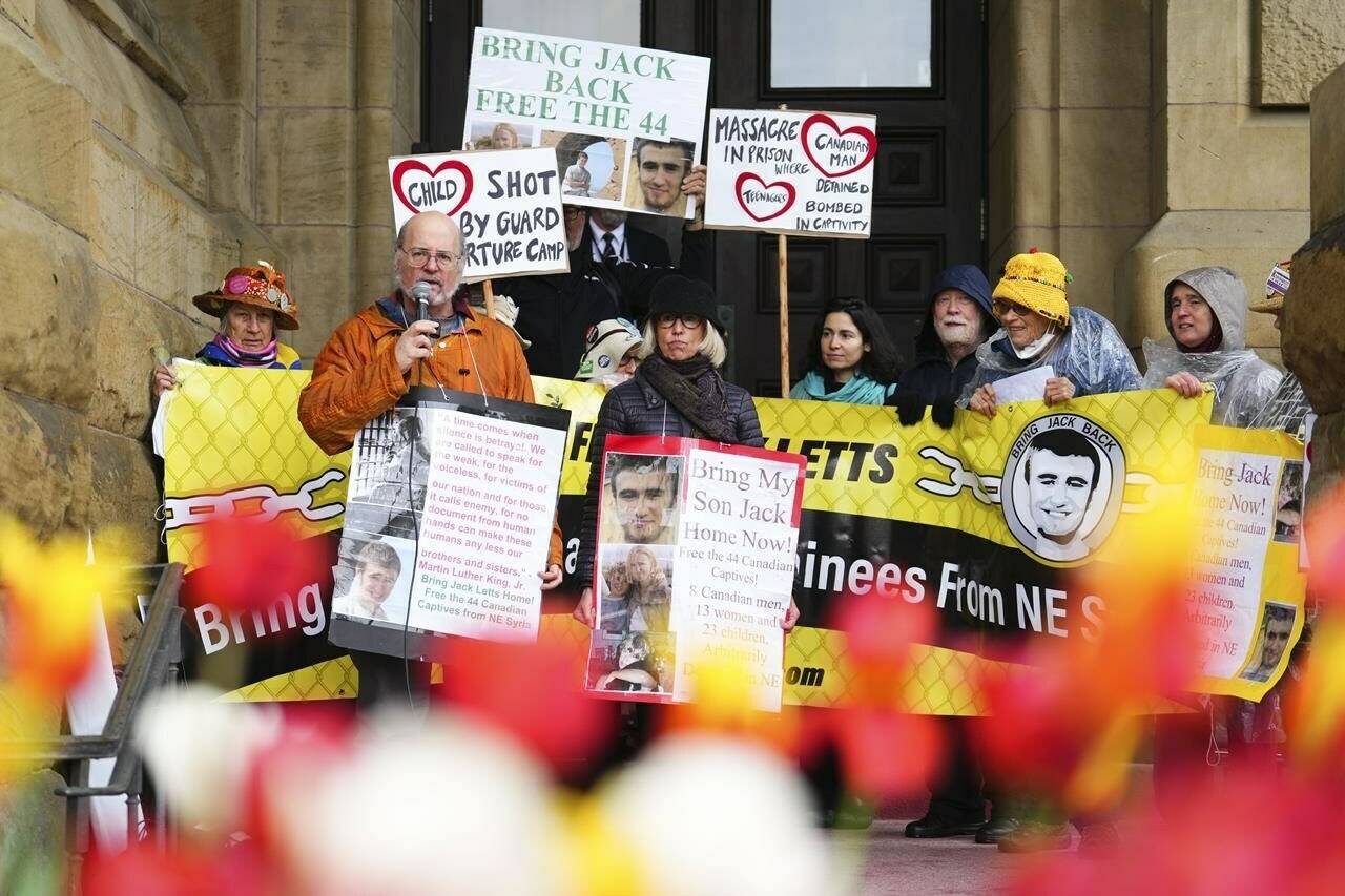 Lawyers for four Canadian men detained in squalid conditions in Syria are telling the Supreme Court that Ottawa is picking and choosing which citizens "to help out of a hellish situation," in violation of their constitutional rights. The four imprisoned Canadian men include Jack Letts, whose parents John Letts and Sally Lane have pressured Ottawa for years to come to his aid. Lane, middle, stands on the steps of the Prime Minister’s office in Ottawa on Thursday May 19, 2022, with supporters. THE CANADIAN PRESS/Sean Kilpatrick