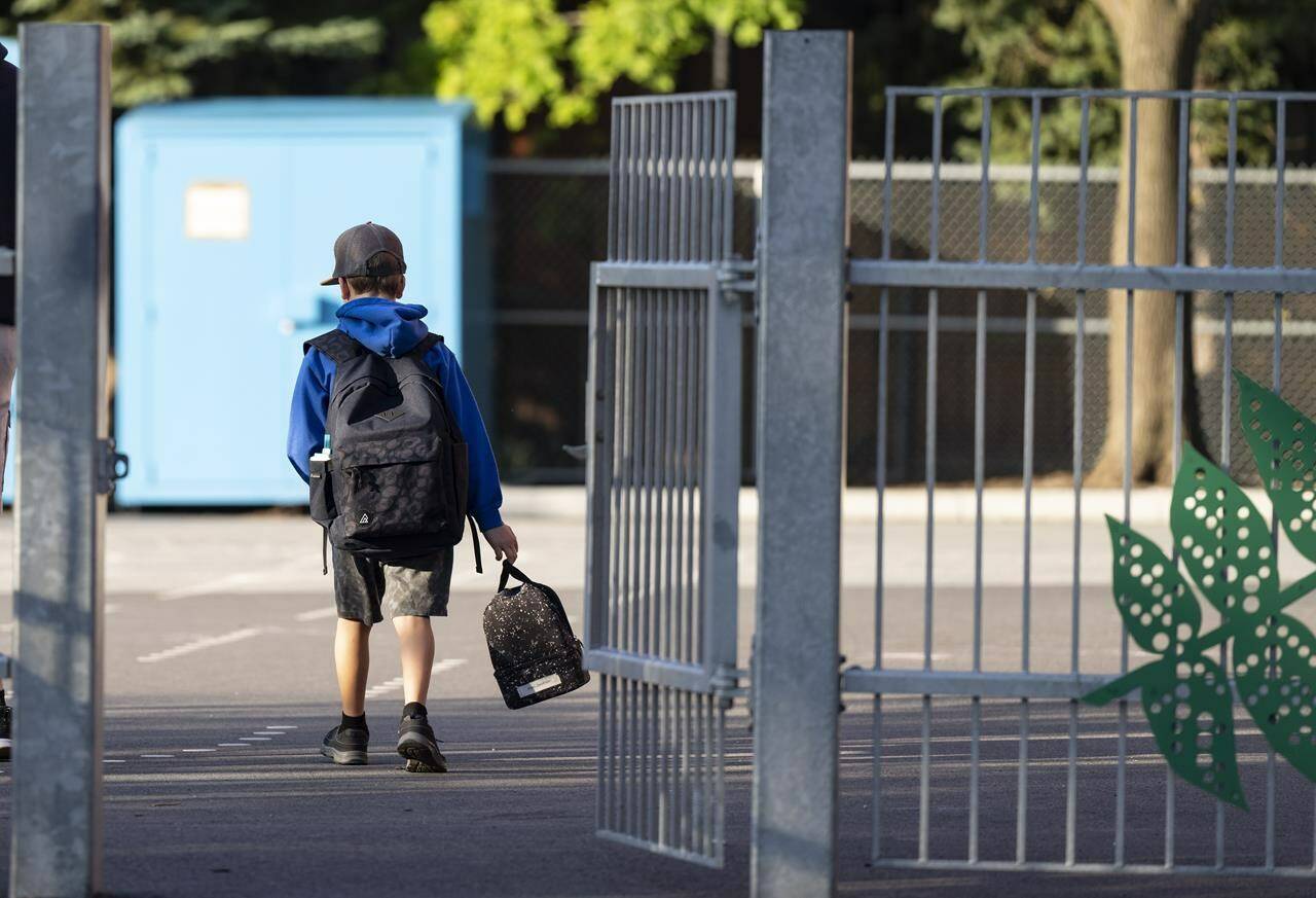 Students across much of Canada are packing lunches and slinging on backpacks today as they bid farewell to summer vacation and gear up for another school year. A elementary student arrives for his first day back to school in Montreal, Monday, Aug. 28, 2023. THE CANADIAN PRESS/Christinne Muschi