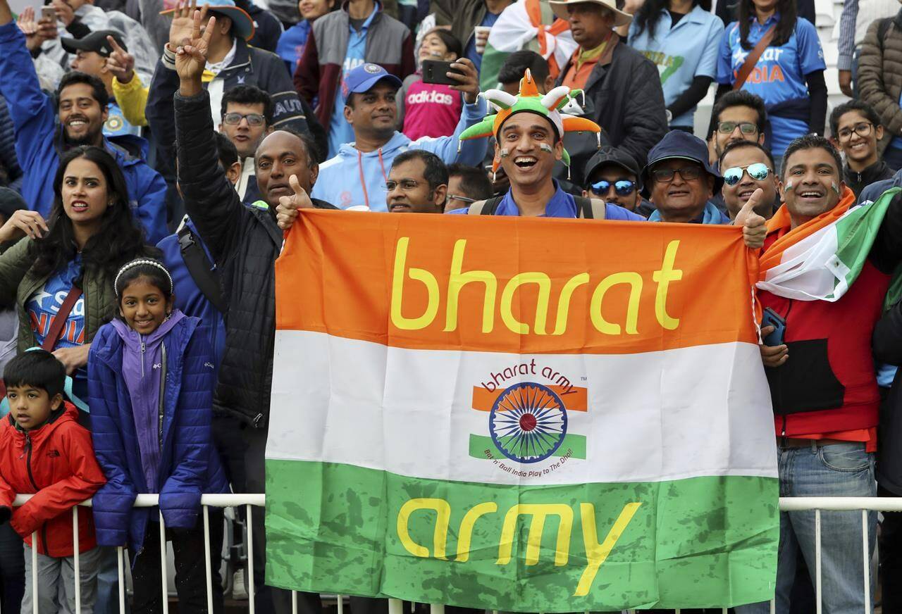 FILE- Indian cricket fans wait for the start of the Cricket World Cup match between India and New Zealand at Trent Bridge in Nottingham, Thursday, June 13, 2019. India has two official names: India, a nomenclature used and accepted in English communication worldwide, and a Sanskrit and Hindi appellation that is “Bharat.” This choice of name is now under spotlight, with Prime Minister Narendra Modi’s government making calls that Indians should rather call their country Bharat and not India. (AP Photo/Rui Vieira, File)