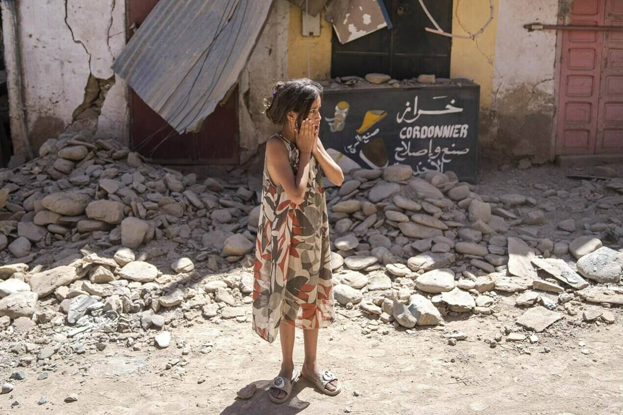 A child reacts after inspecting the damage caused by the earthquake, in her town of Amizmiz, near Marrakech, Morocco, Sunday, Sept. 10, 2023. THE CANADIAN PRESS/AP/Mosa’ab Elshamy