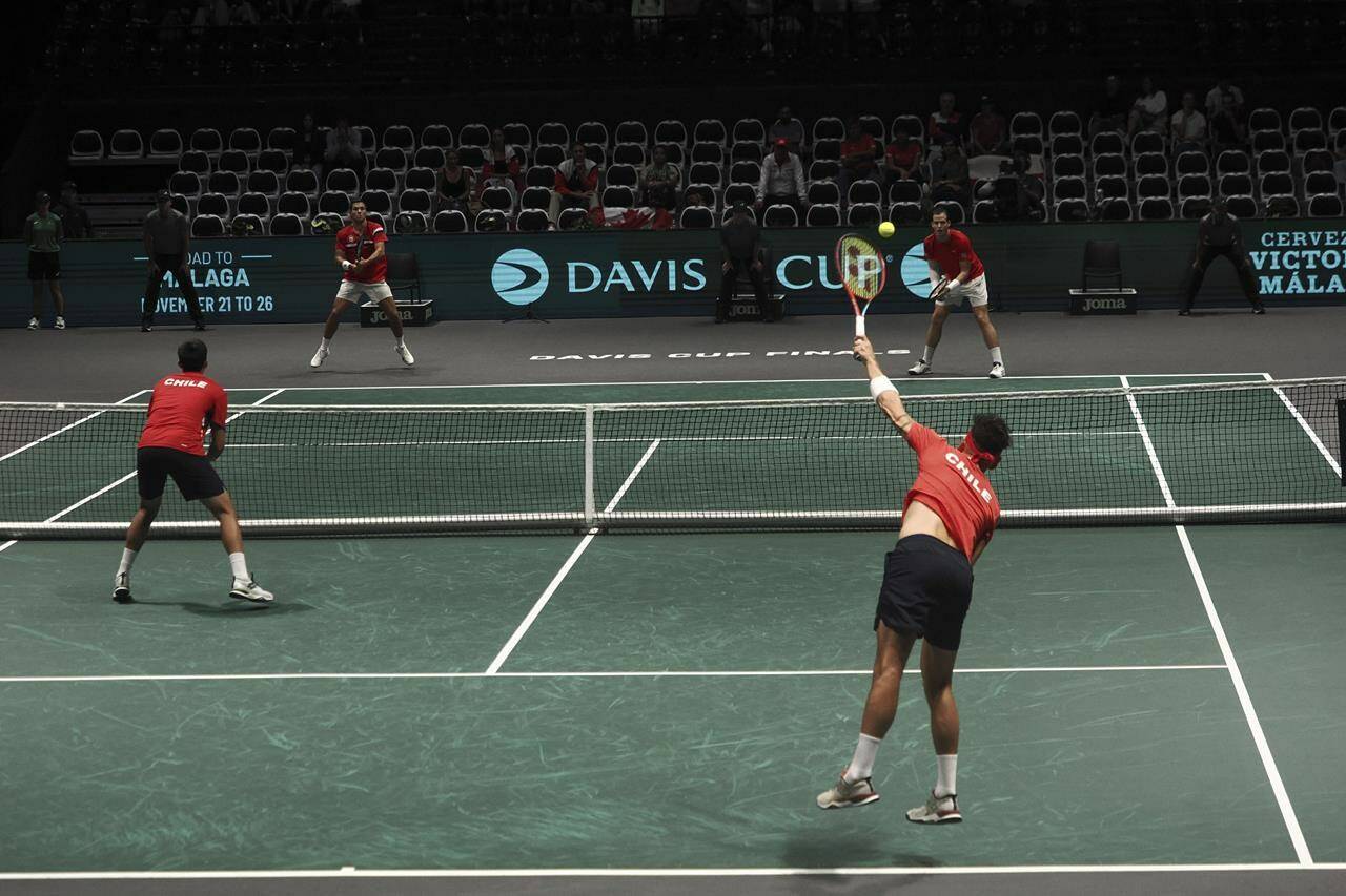 Chile’s Alejandro Tabilo serves next to his teammate Chile’s Tomas Barrios Vera during their doubles Davis Cup group A tennis match against Canada’s Alexis Galarneau and Canada’s Vasek Pospisil, in Bologna, Saturday Sept. 16, 2023. (Michele Nucci/LaPresse via AP)