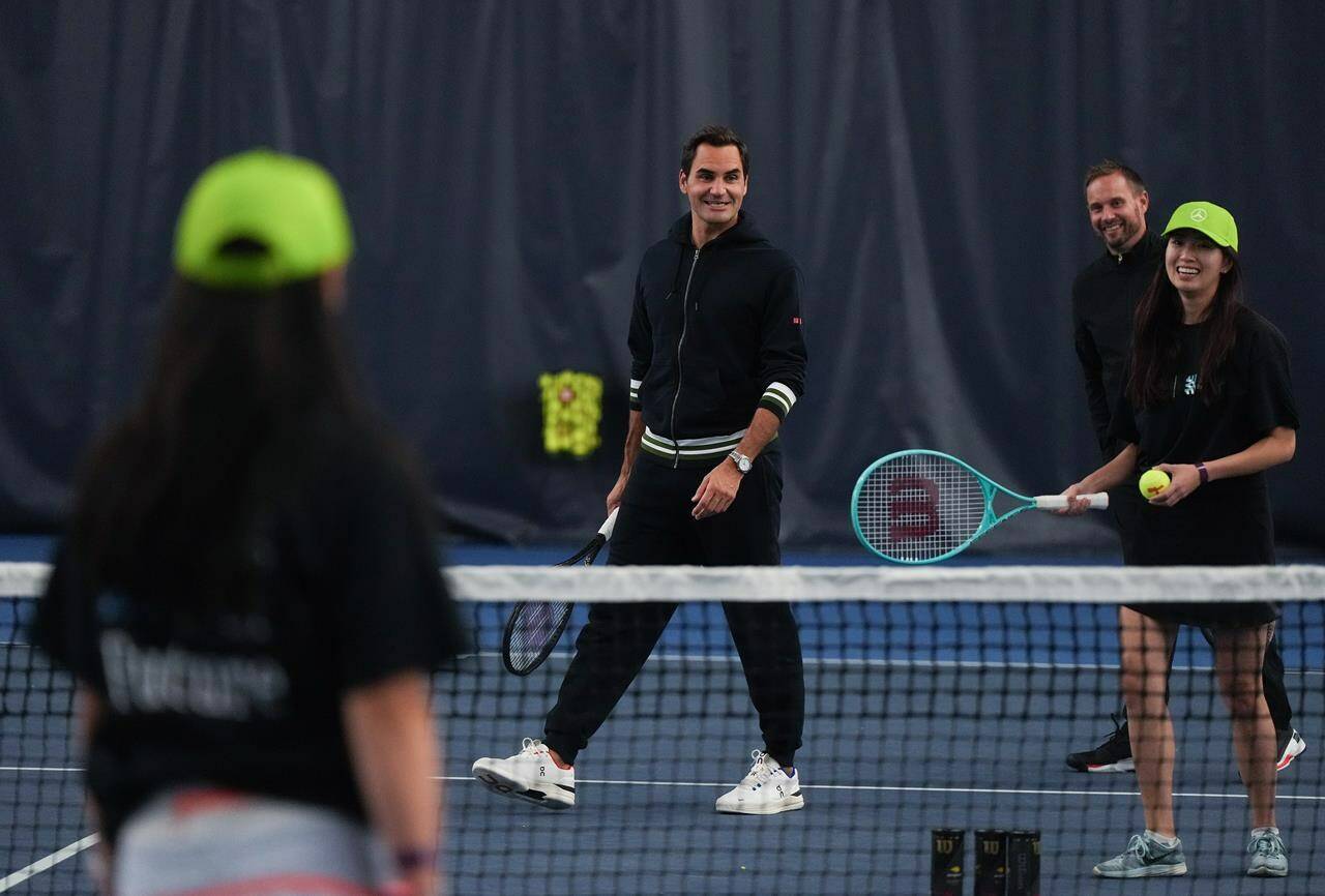 Retired tennis player Roger Federer participates in a tennis clinic for kids from the Vancouver chapters of Big Brothers and Big Sisters, as part of a partnership with Mercedes-Benz Canada, in Vancouver, on Tuesday, September 19, 2023. Federer is in the city for the 2023 Laver Cup tennis tournament that he co-founded. THE CANADIAN PRESS/Darryl Dyck