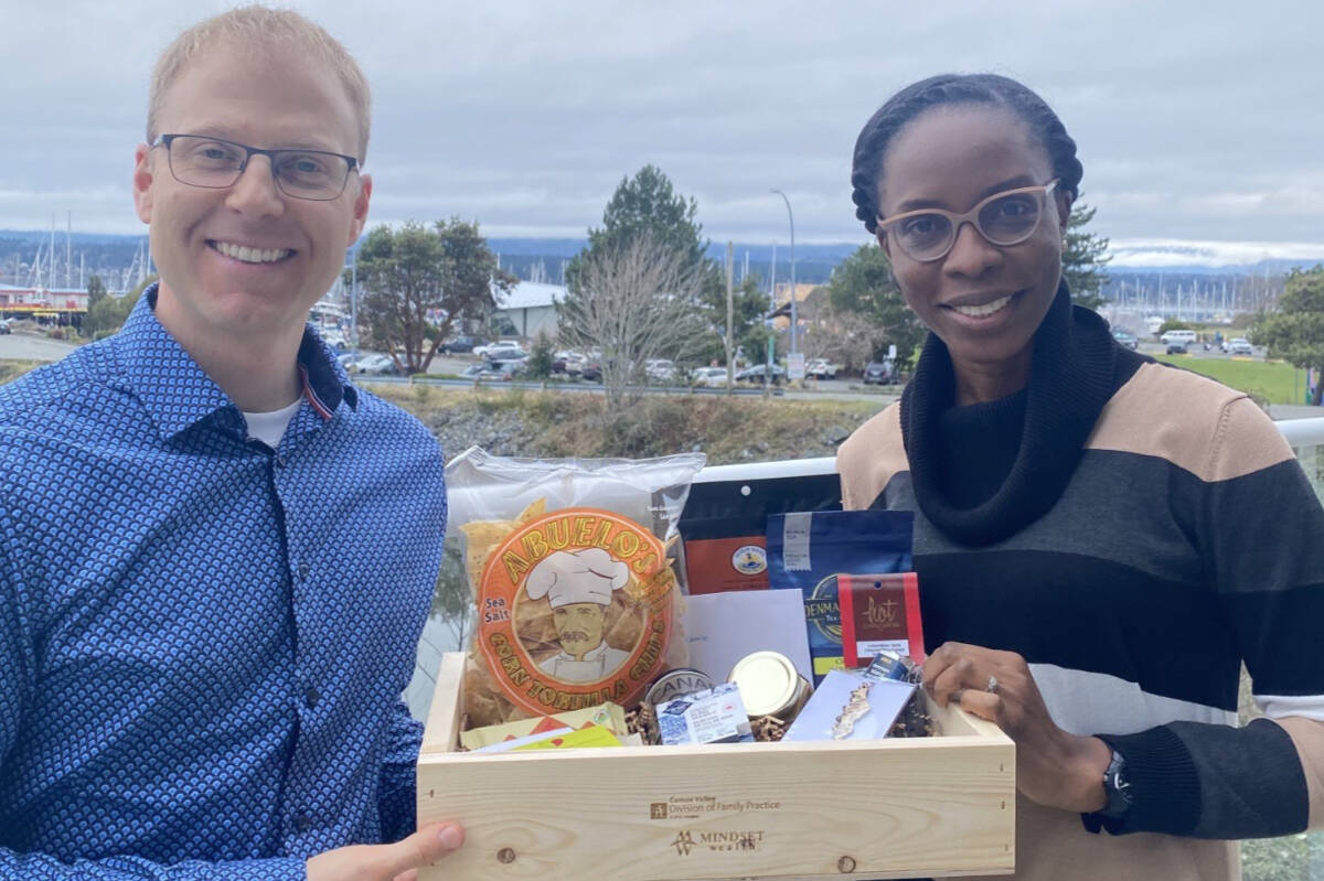 Jonathan Kerr and Dr. Eberechi Adenle receiving her welcome gift. (Photo submitted)