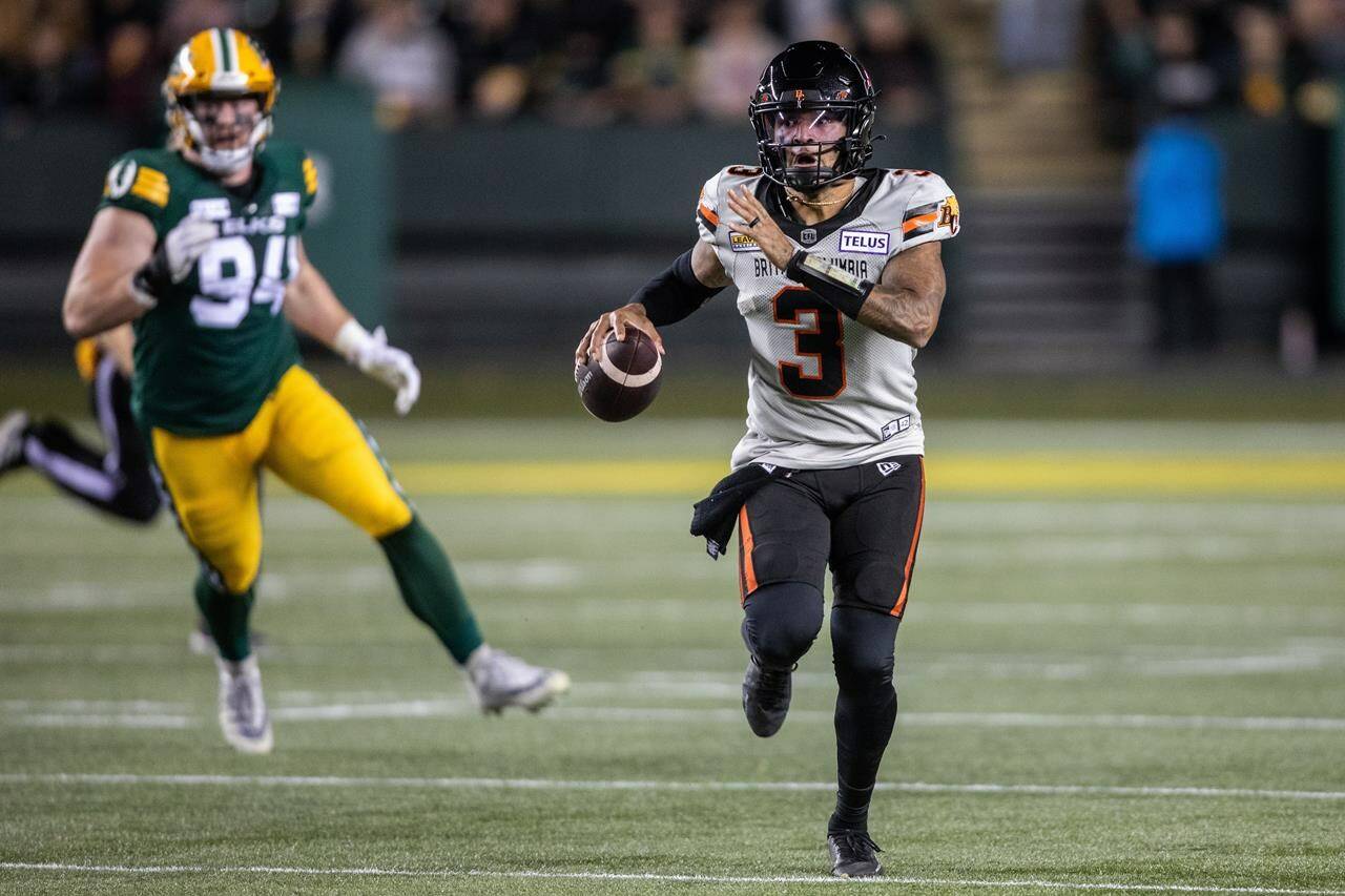 B.C. Lions quarterback Vernon Adams Jr. (3) runs the ball as Edmonton Elks’ Jake Ceresna (94) looks on during first half CFL action in Edmonton on Friday, September 22, 2023. THE CANADIAN PRESS/Amber Bracken