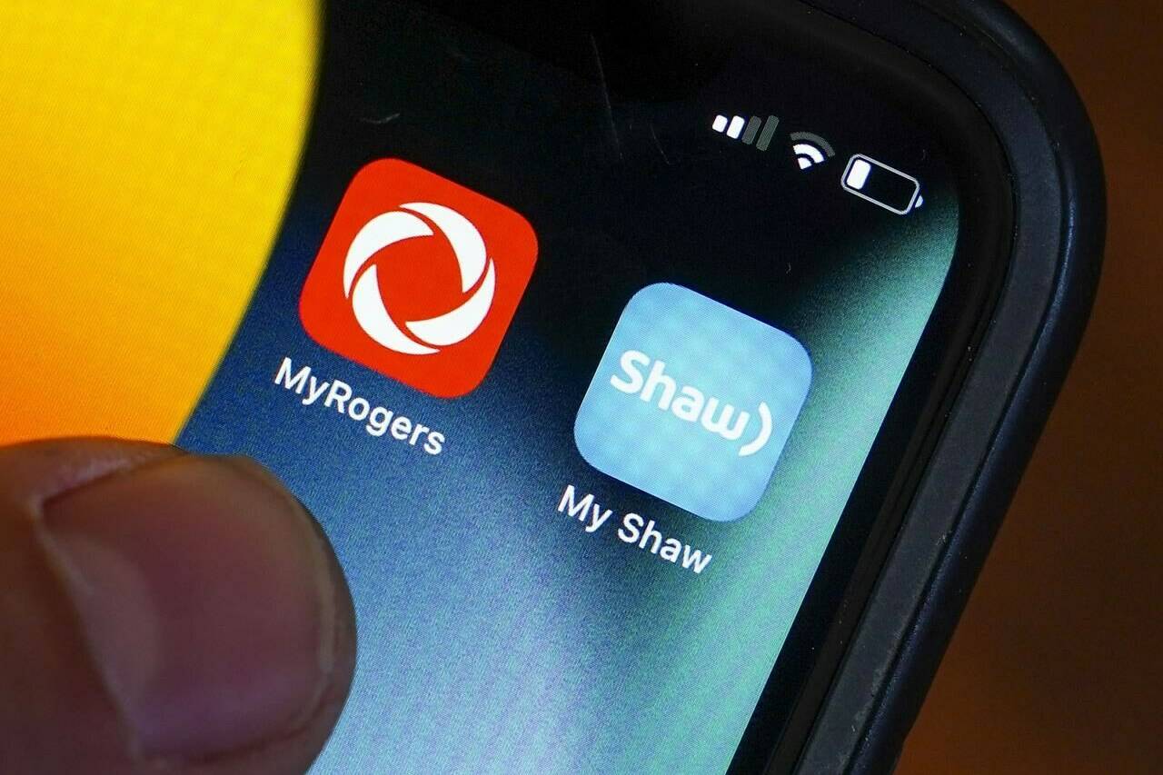 Rogers and Shaw applications are pictured on a cellphone in Ottawa on Monday, May 9, 2022. THE CANADIAN PRESS/Sean Kilpatrick