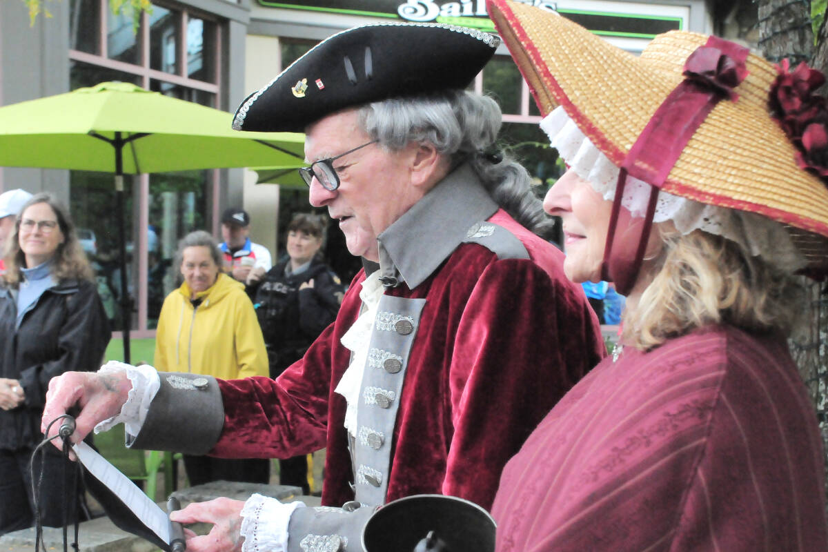 Qualicum Beach town crier Len Mustard and wife Marie address the Tour De Rock 2023 riders when they stopped at the town square. (Michael Briones photo)