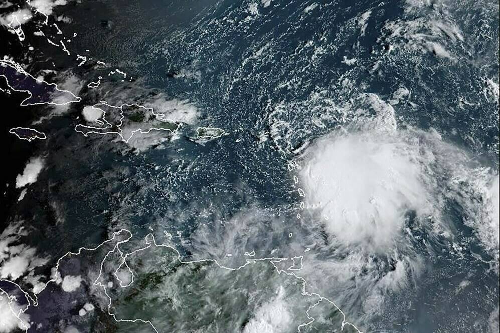 This satellite image provided by NOAA on Monday, Oct. 2 2023 shows Tropical Storm Philippe, center right. Philippe is threatening to unleash heavy rains and flash flooding in the Leeward Islands on Monday before eventually recurving out into the central Atlantic where it could gain hurricane status around midweek, forecasters say. (NOAA via AP)