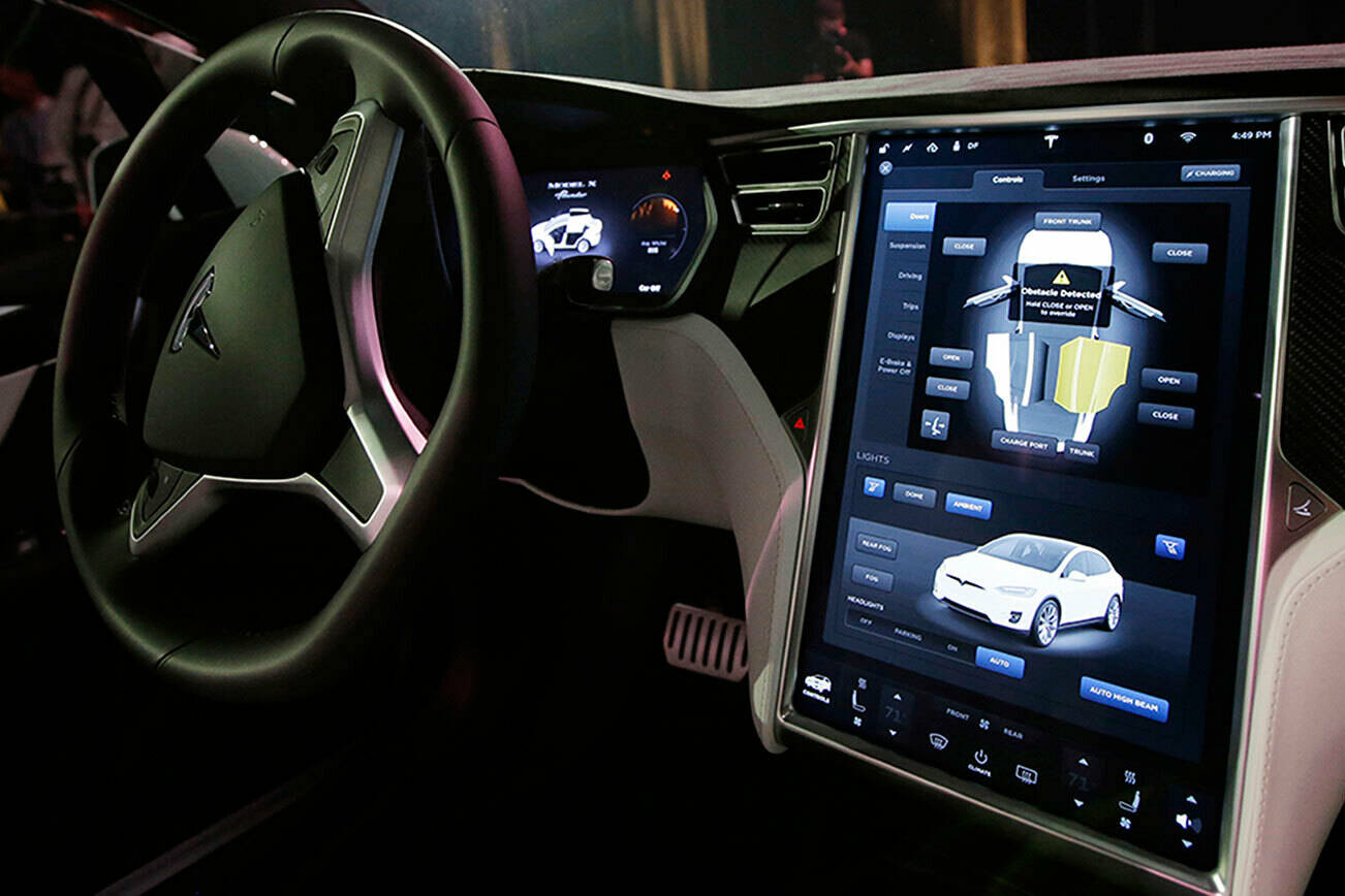FILE - This Tuesday, Sept. 29, 2015, file photo shows the dashboard of the Tesla Model X car, at the company’s headquarters in Fremont, Calif. (AP Photo/Marcio Jose Sanchez, File)