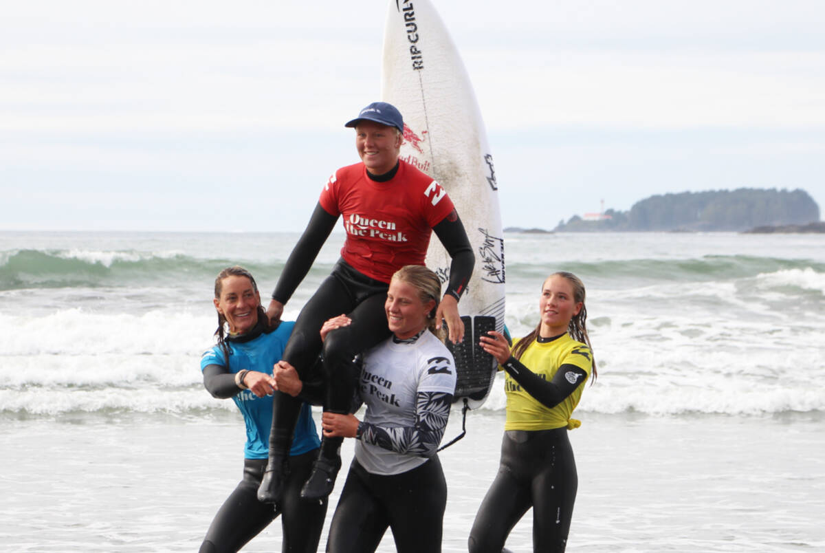 Mathea Olin is carried out of the waves after winning the Queen of the Peak’s shortboard finals at Cox Bay. (Andrew Bailey photo)