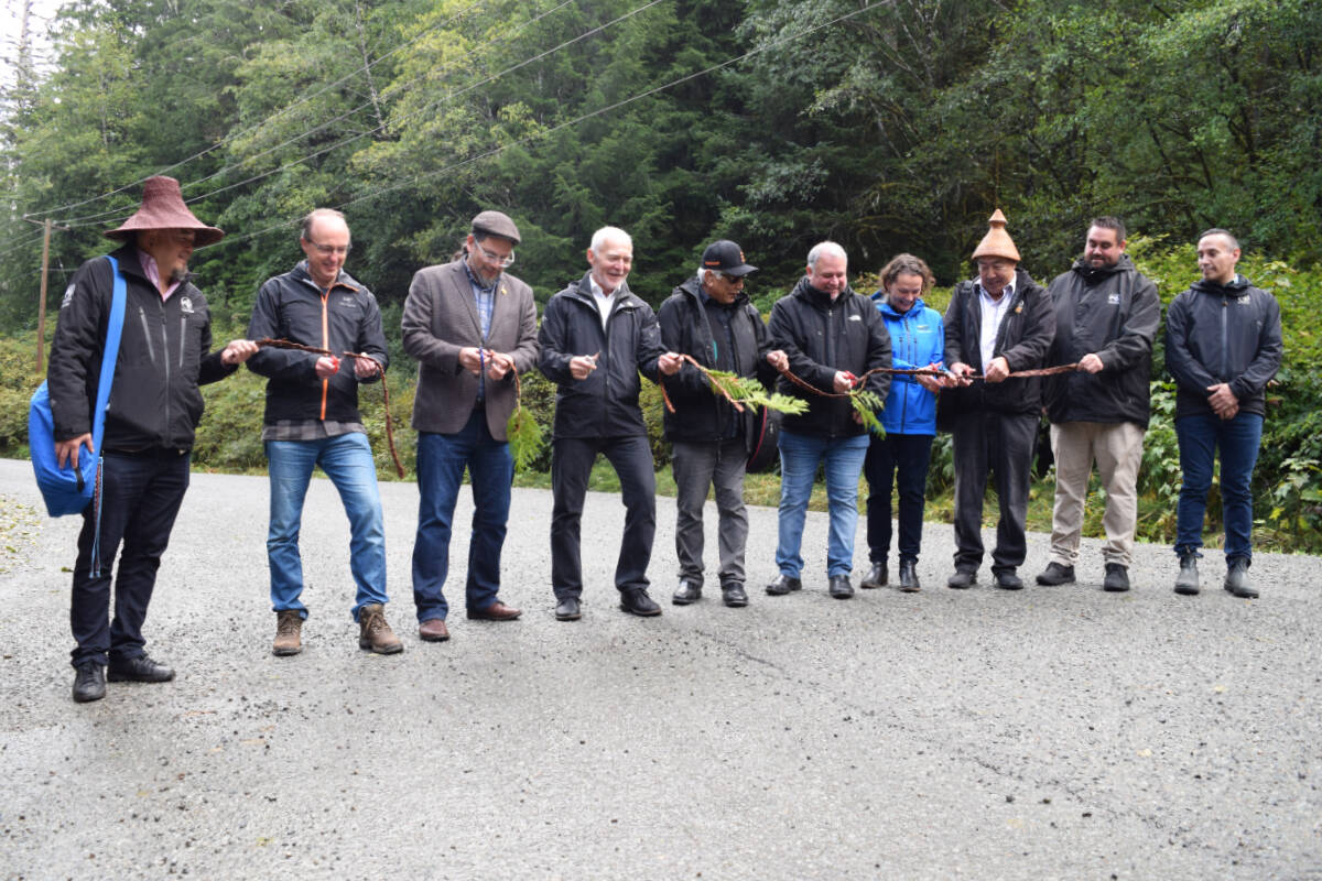 The ribbon is cut to officially mark the opening of the new chip-sealed Bamfield Main. (ELENA RARDON / Alberni Valley News)