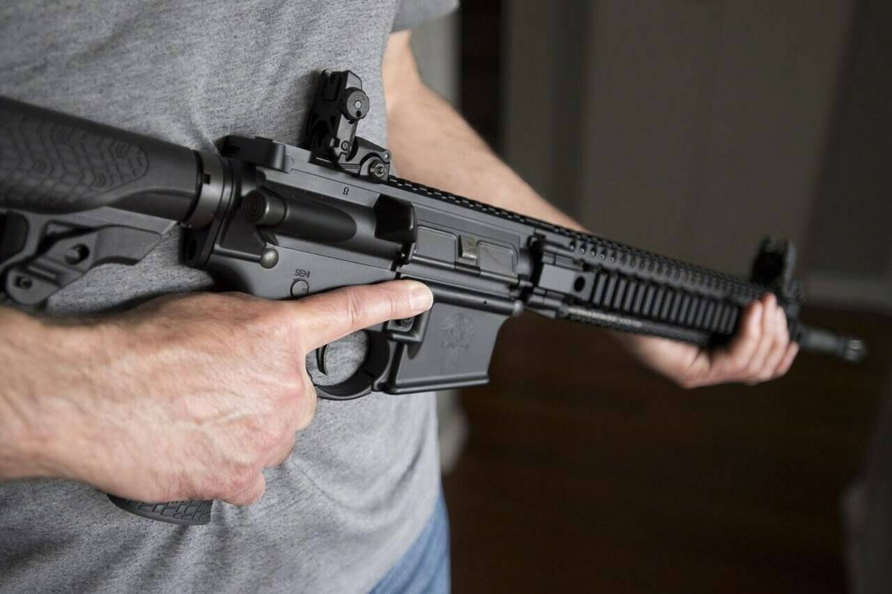 A restricted gun licence holder holds a AR-15 in Langley, B.C. on May 1, 2020. The federal Liberal government says it is extending an amnesty on guns it prohibited in the wake of the deadly Nova Scotia shooting rampage for an extra two years. THE CANADIAN PRESS/Jonathan Hayward