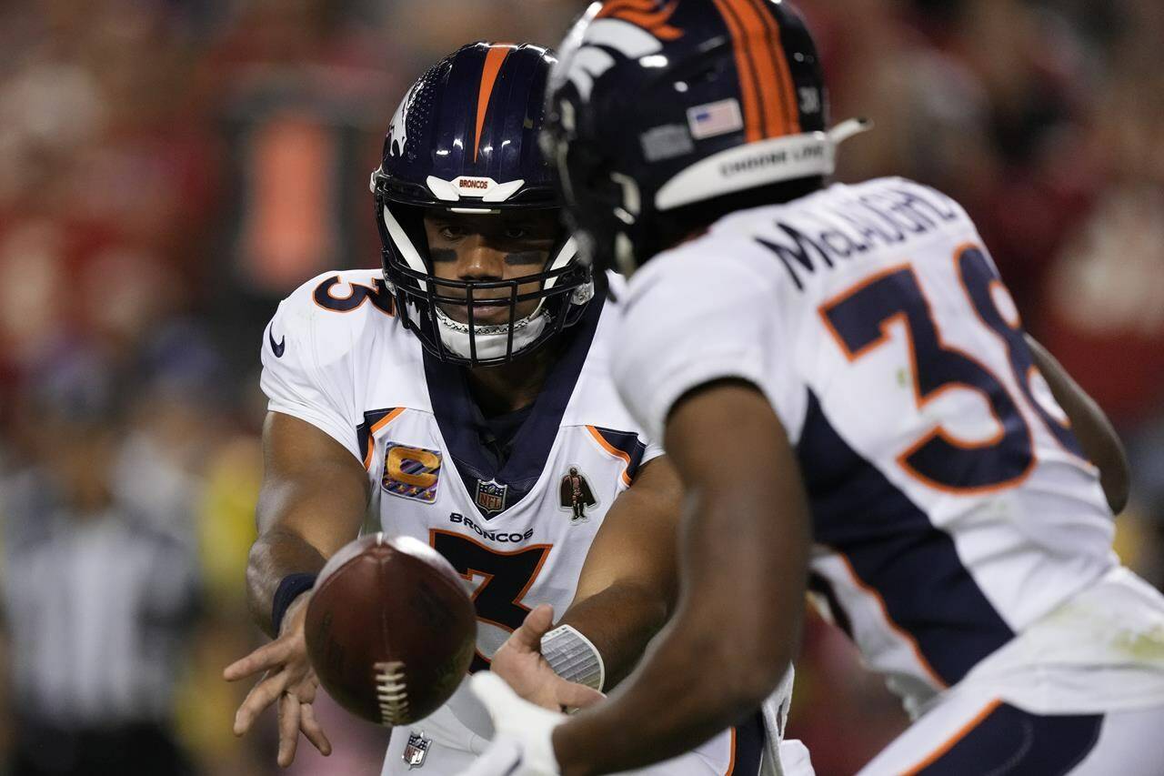 Denver Broncos quarterback Russell Wilson (3) tosses to Jaleel McLaughlin during the first half of an NFL football game against the Kansas City Chiefs, Thursday, Oct. 12, 2023, in Kansas City, Mo. (AP Photo/Charlie Riedel)