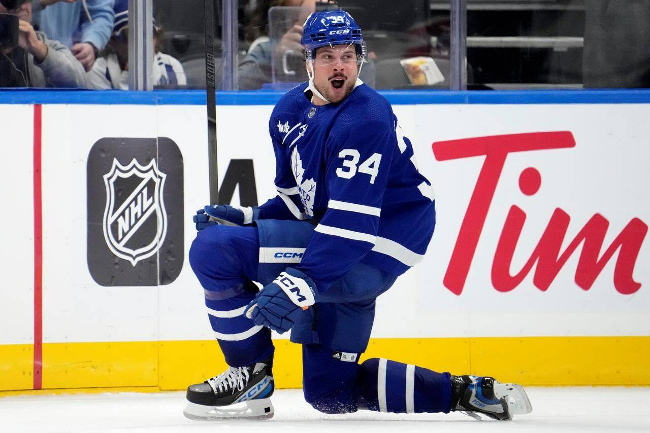 Toronto Maple Leafs centre Auston Matthews (34) celebrates after scoring his third goal of the game past Minnesota Wild goaltender Filip Gustavsson (32) during third period NHL hockey action, in Toronto, Saturday, Oct. 14, 2023. Matthews has been named the NHL's first star of its opening week of the 2023-24 season after he posted hat tricks in the Maple Leafs' first two games. THE CANADIAN PRESS/Frank Gunn