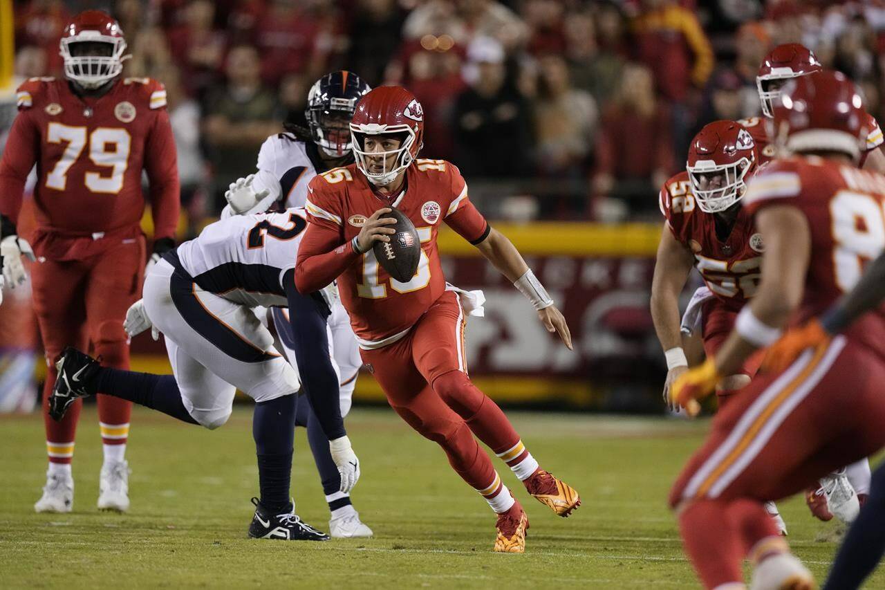 Kansas City Chiefs quarterback Patrick Mahomes (15) runs during the first half of an NFL football game against the Denver Broncos, Thursday, Oct. 12, 2023, in Kansas City, Mo. (AP Photo/Charlie Riedel)