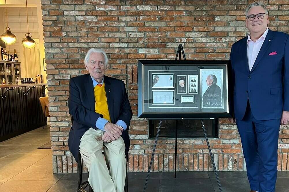 Donald Sutherland and Canada Post President and CEO Doug Ettinger pose with a framed stamp enlargement in a handout photo. THE CANADIAN PRESS/HO-Rossif Sutherland
