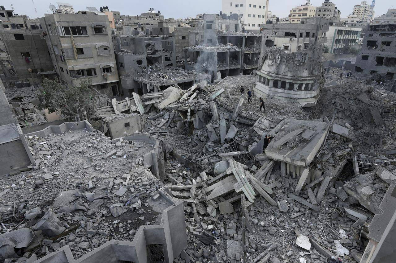 Palestinians inspect the rubble of the Yassin Mosque destroyed after it was hit by an Israeli airstrike at Shati refugee camp in Gaza City, early Monday, Oct. 9, 2023. (AP Photo/Adel Hana, File)