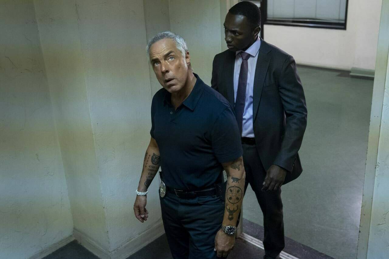 This image released by Amazon shows Titus Welliver, left, and Jamie Hector in a scene from the series “Bosch,” based on the book series by Michael Connelly. (Saeed Adyani/Amazon via AP)