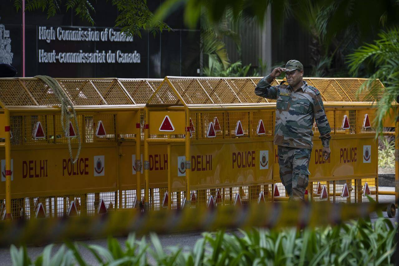 An Indian paramilitary soldier stands guard next to a police barricade outside the Canadian High Commission in New Delhi, India, Tuesday, Sept. 19, 2023.India is defending its diplomatic actions a day after Ottawa announced it had pulled most of its envoys from the country over what it called a precedent-setting diplomatic threat. THE CANADIAN PRESS/AP/Altaf Qadri