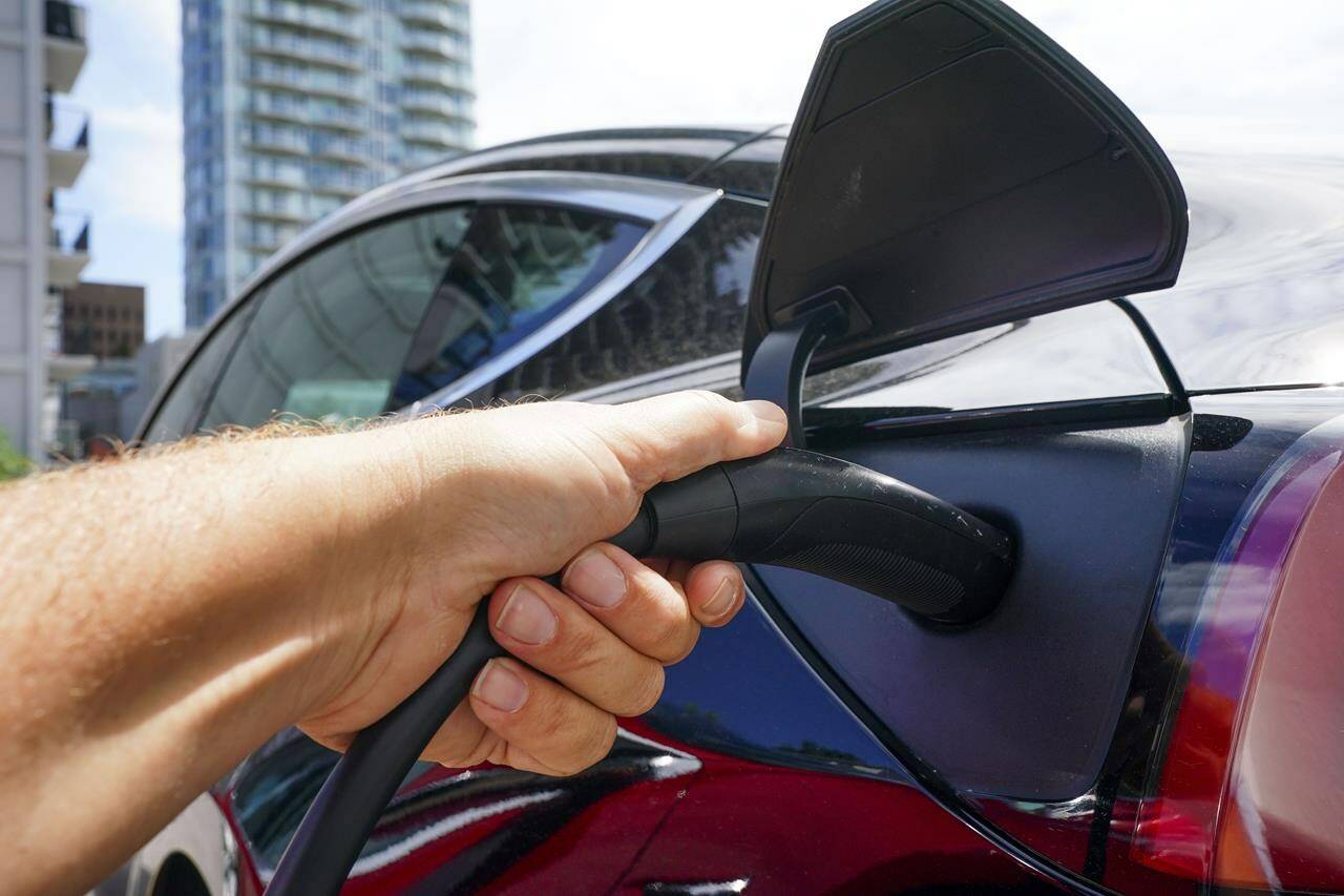 An electric vehicle is charged in Ottawa on Wednesday, July 13, 2022. (THE CANADIAN PRESS/Sean Kilpatrick)