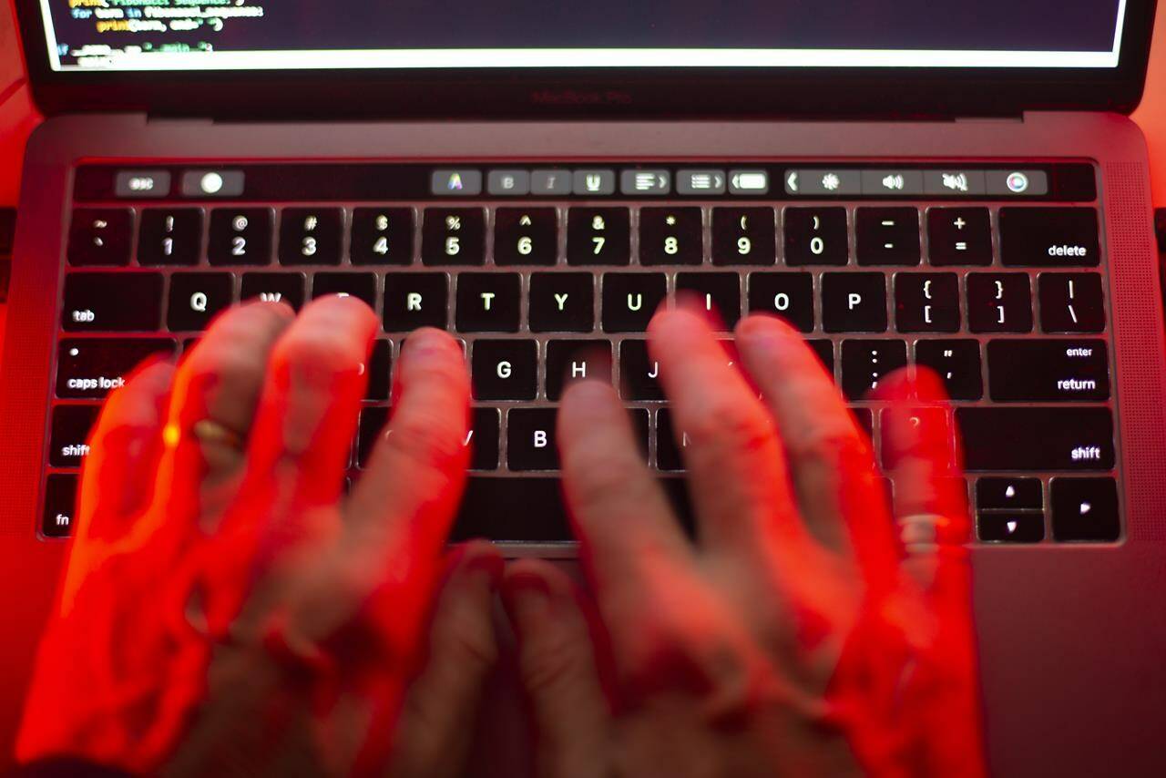 A man uses a computer keyboard in Toronto in this Sunday, Oct. 9, 2023 photo illustration. Global accounting firm KPMG says cybercrime is a growing issue in Metro Vancouver and on Vancouver Island. THE CANADIAN PRESS/Graeme Roy