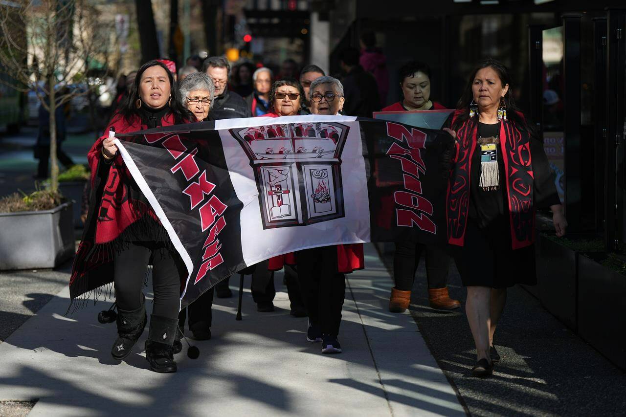 Members of the Gitxaala Nation, including Chief Councillor Linda Innes, front right, march to B.C. Supreme Court in Vancouver, B.C., Monday, April 3, 2023. The refusal of Justice Alan Ross to enforce UNDRIP laws is one of the decisions the First Nations is appealing. (THE CANADIAN PRESS/Darryl Dyck)