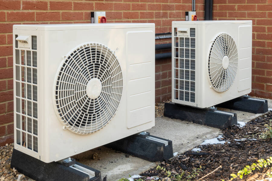Two air source heat pumps installed on the exterior of a house. The Capital Regional District offers discounts to switch from an oil, natural gas, or propane heating system to an air source heat pump. (Shutterstock)